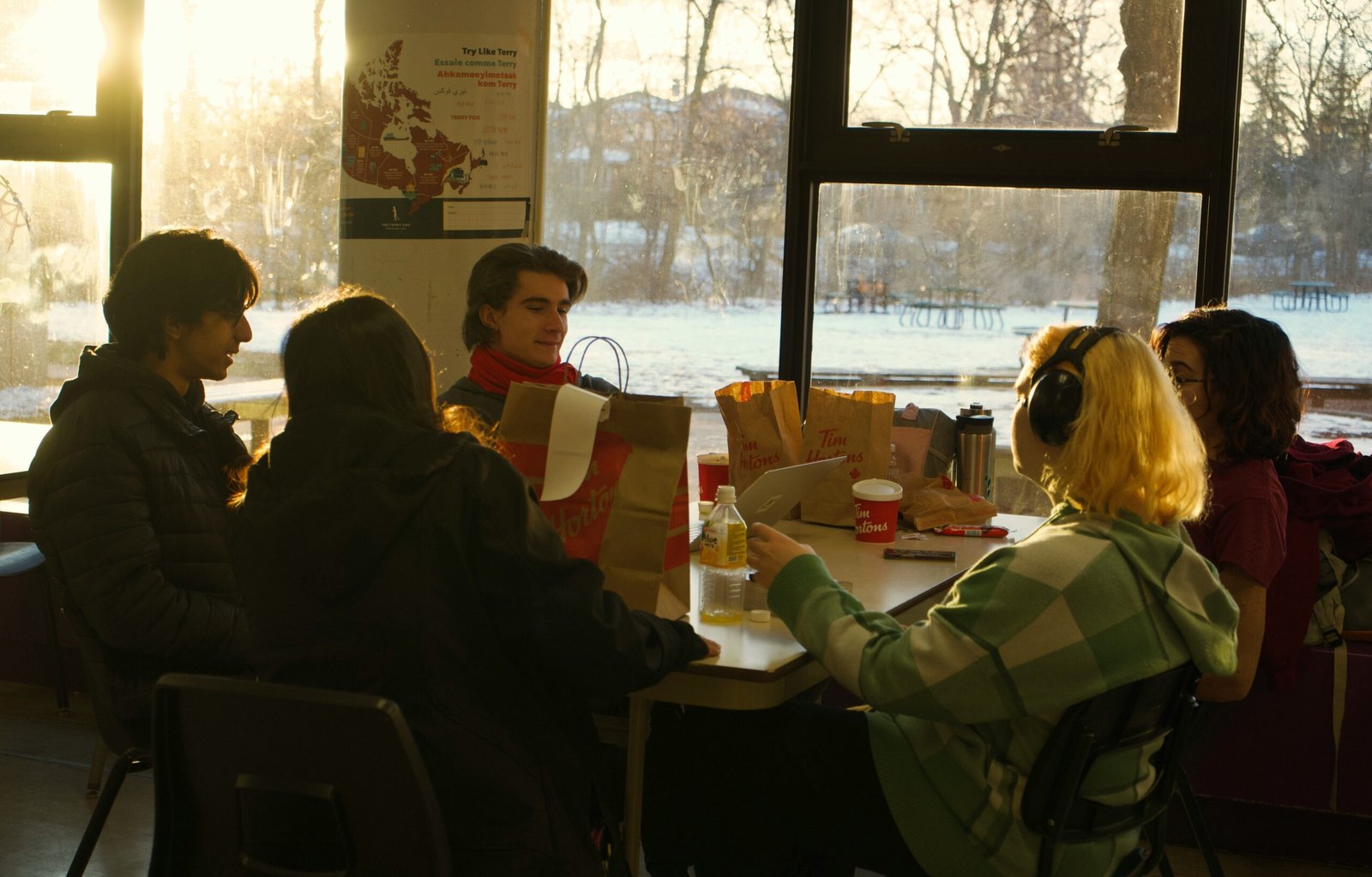 A group of young writers sit in a diner and participate in their creative writing classes.
